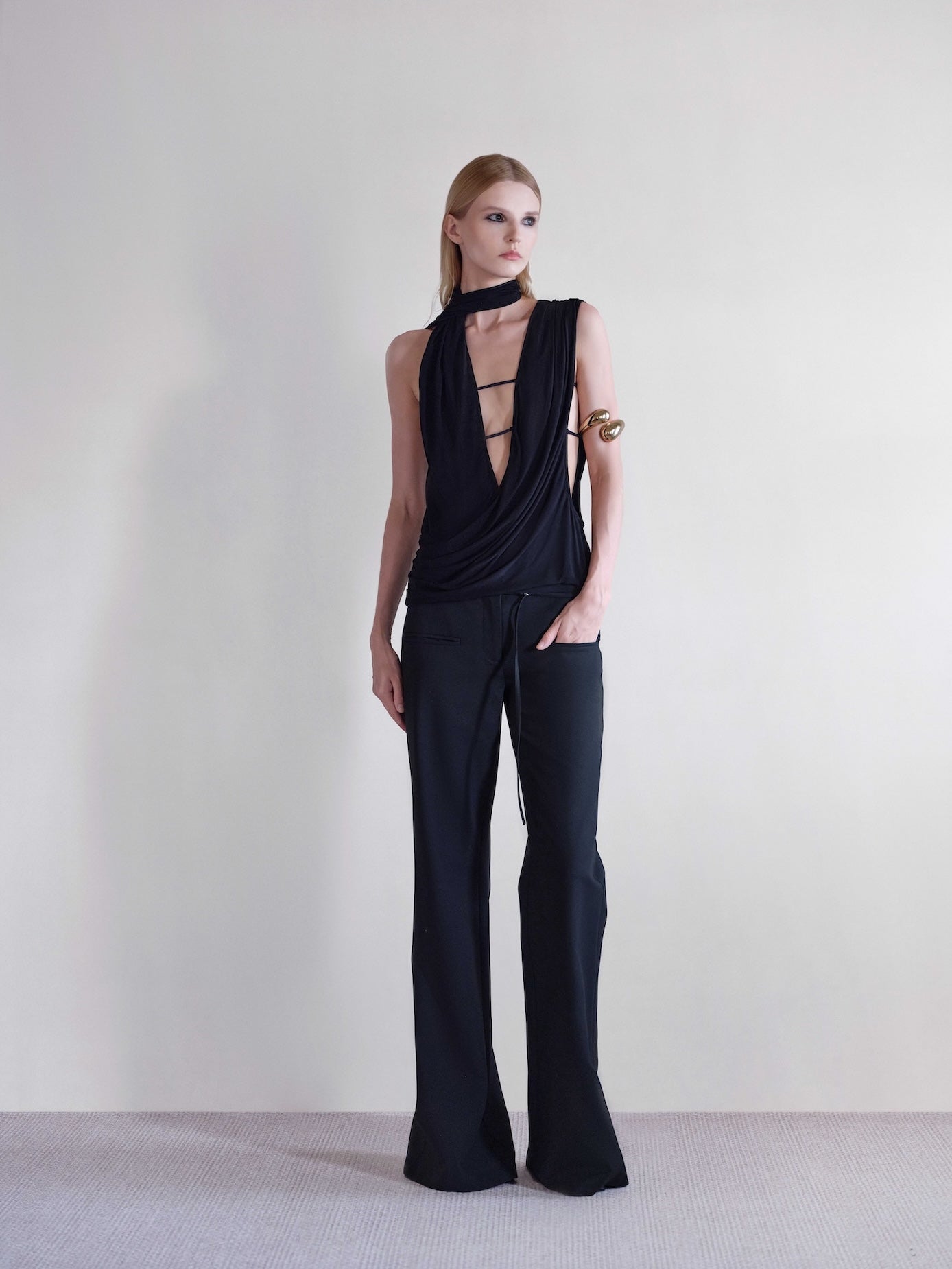 Väme Sway Wrapped Top front view  – black asymmetric draped top with straps.