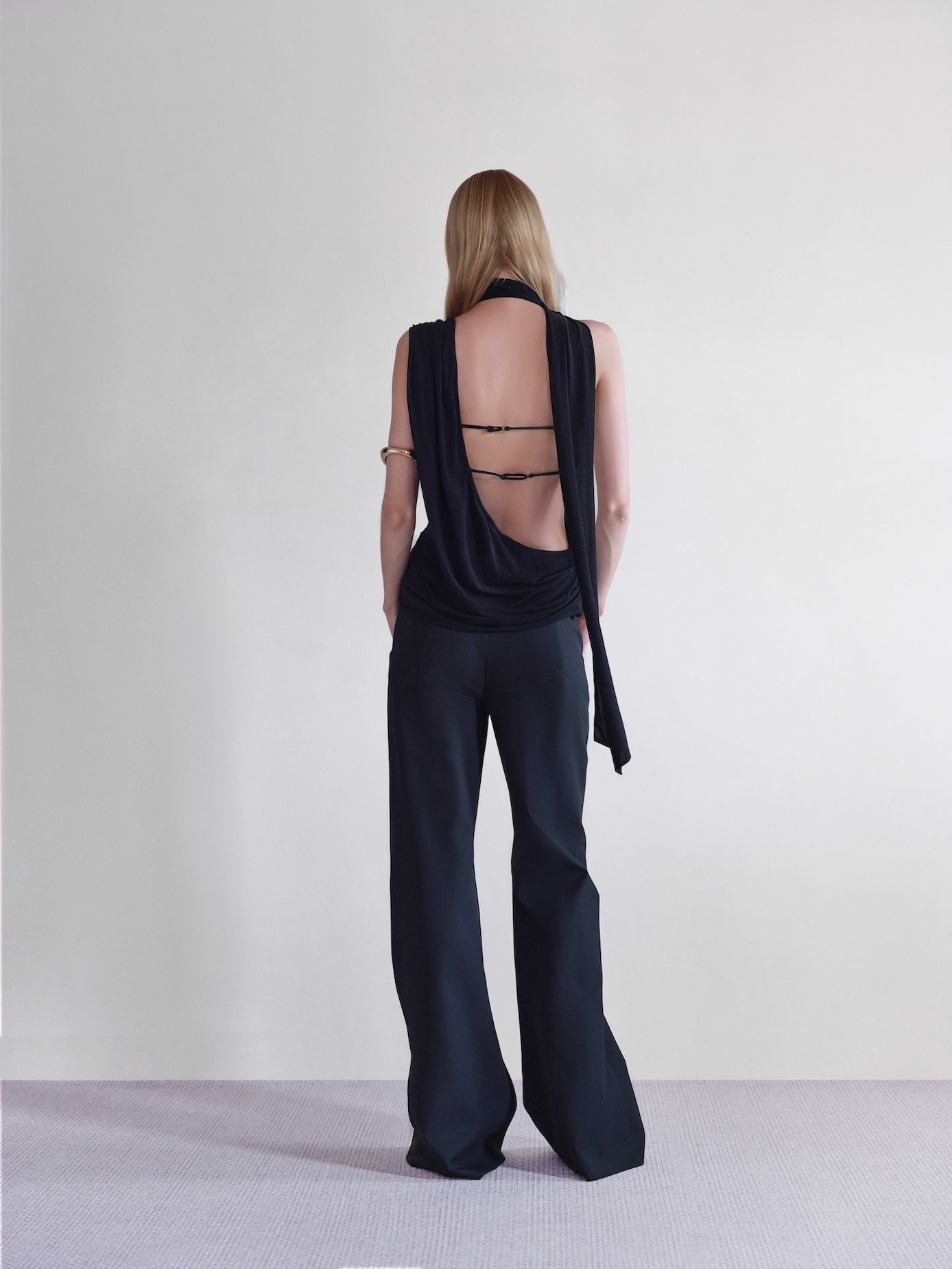 Väme Sway Wrapped Top back view –  black asymmetric draped top with straps.